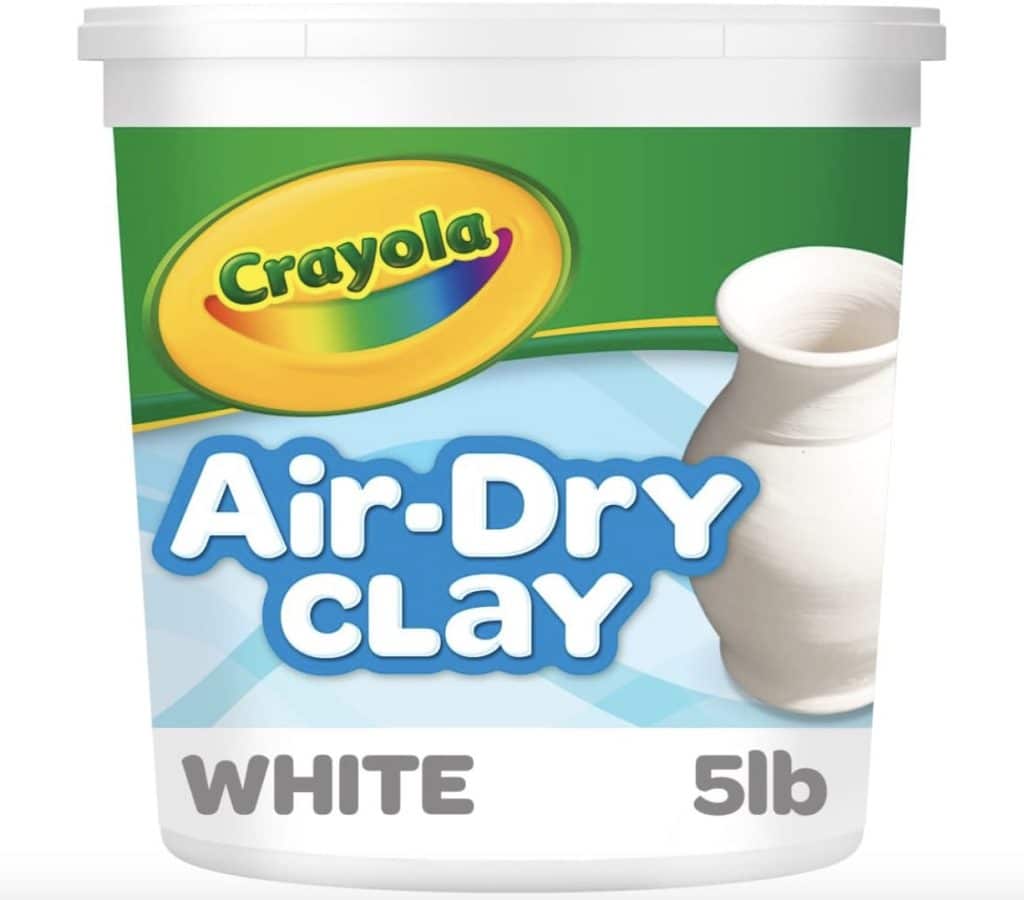 A container of Crayola Air-Dry Clay in white, 5 pounds. The label features a colorful Crayola logo and an image of a white clay pot, perfect for crafting your own air-dry clay house.